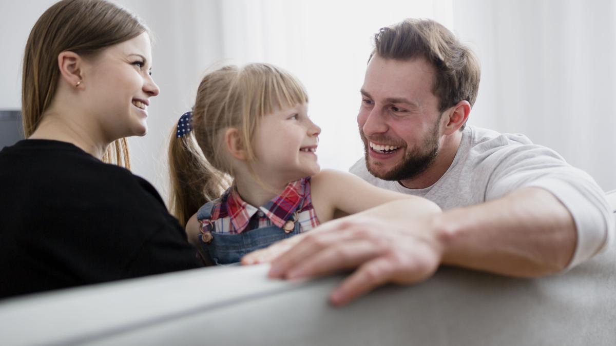 cheerful-family-sitting-couch_97672100