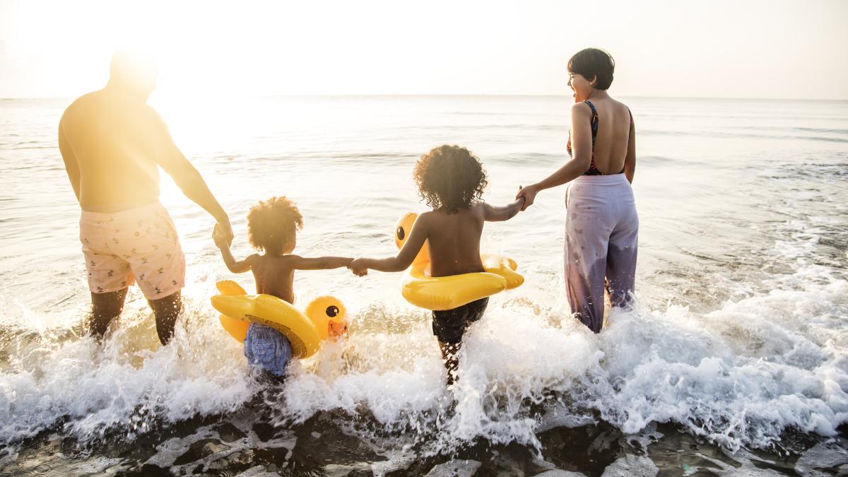 black-family-having-fun-beach_31801900