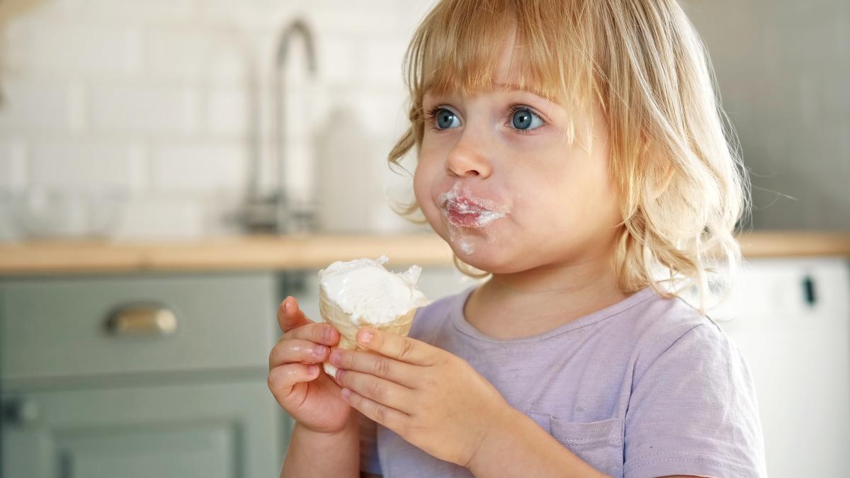 baby-girl-enjoying-ice-cream-pretty-little-toddler-eating-icecream-indoors-home-dining-room-background-small-child-eats-plombir-cream-messy-her-mouth-cute-kid-with-tasty-sweet-food_23973200