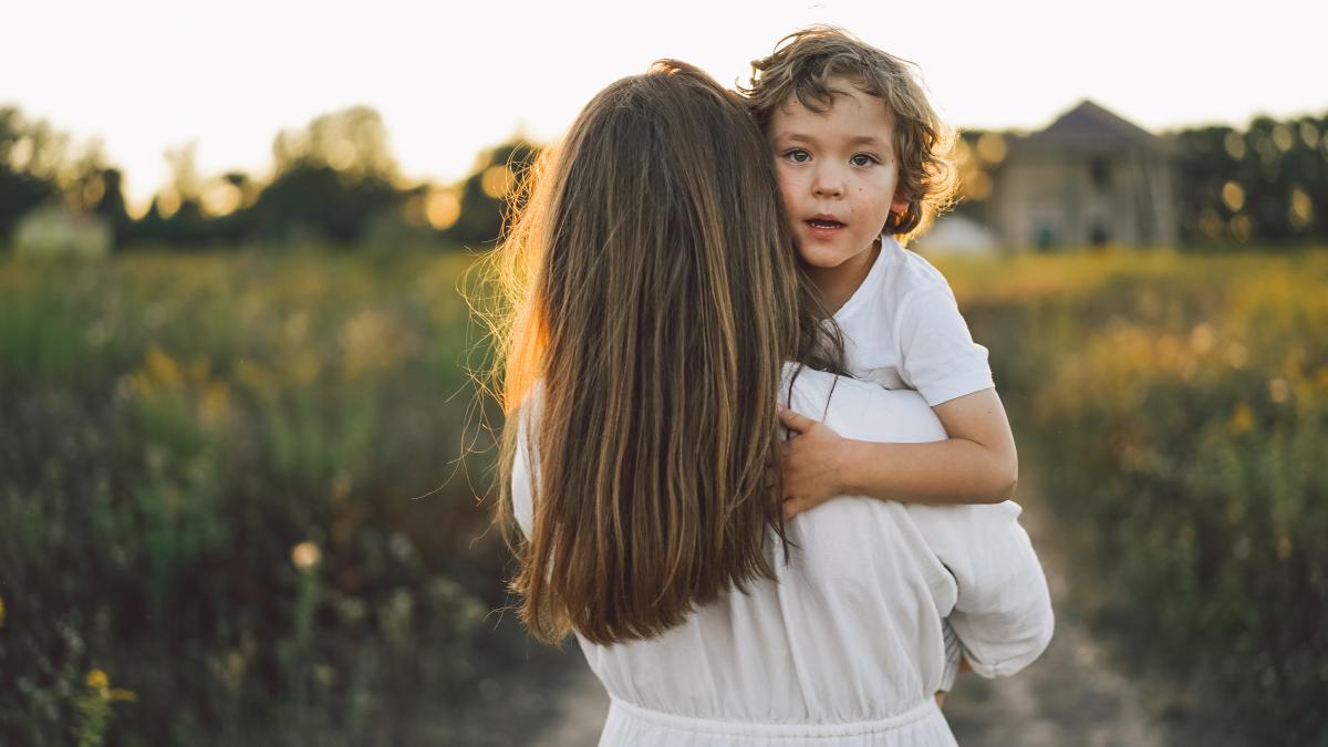 woman-playing-with-her-child-outdoors_91683600