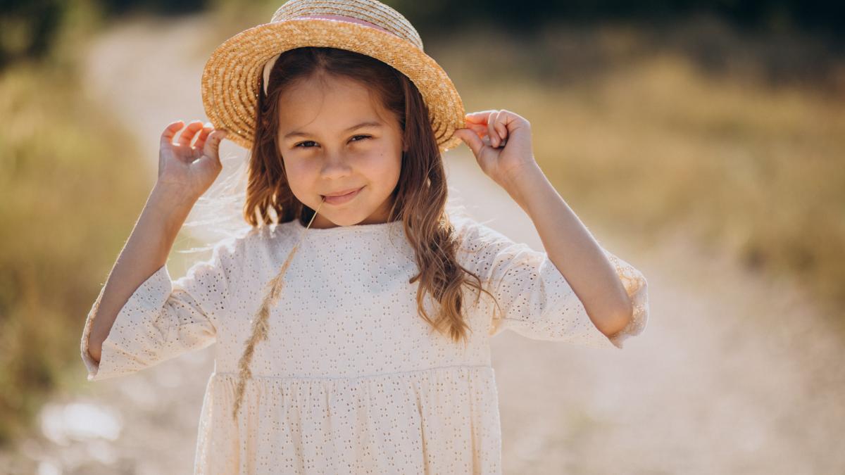 cute-girl-wearing-hat-walking-meadow_06715100