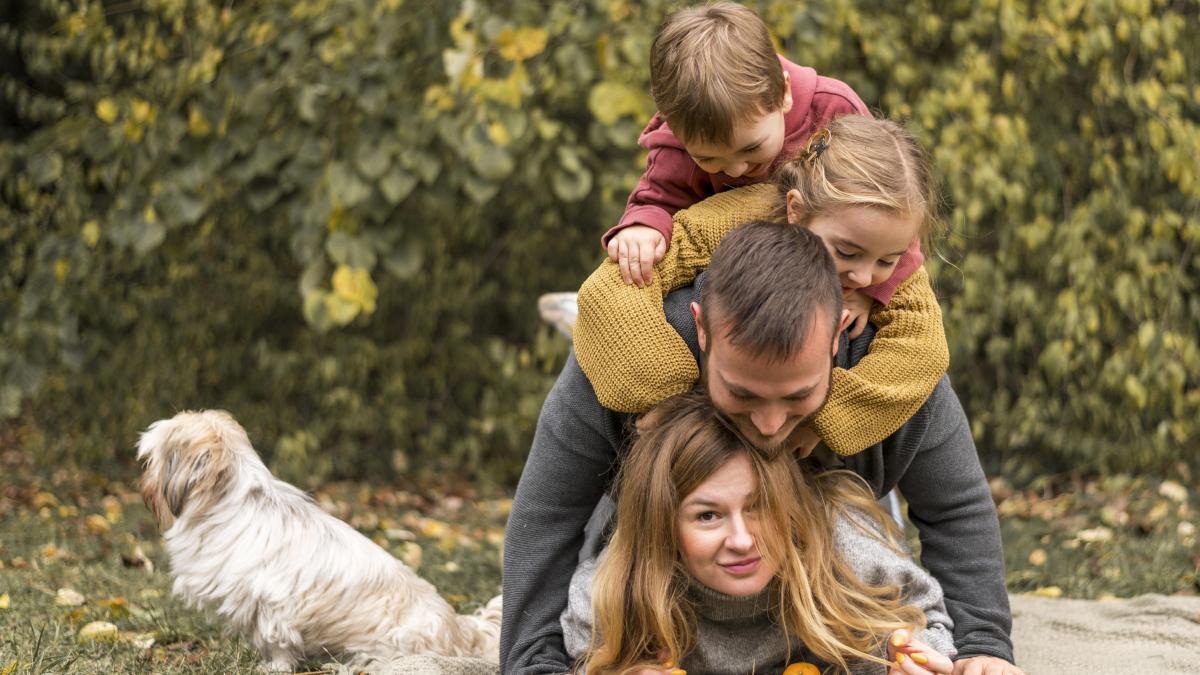 full-shot-family-having-fun-with-dog_20159800