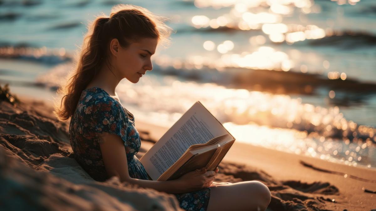young-woman-reads-book-beach_61916300