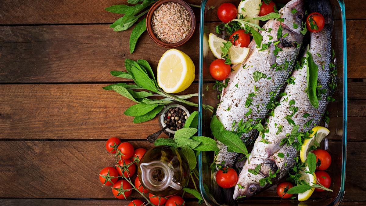 two-raw-seabass-baking-dish-with-spices-old-wooden-table-top-view_34514600