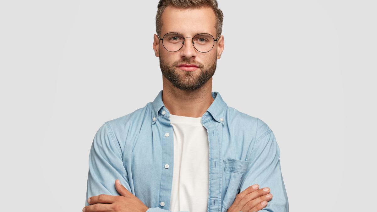 handsome-bearded-guy-posing-against-white-wall_03556600