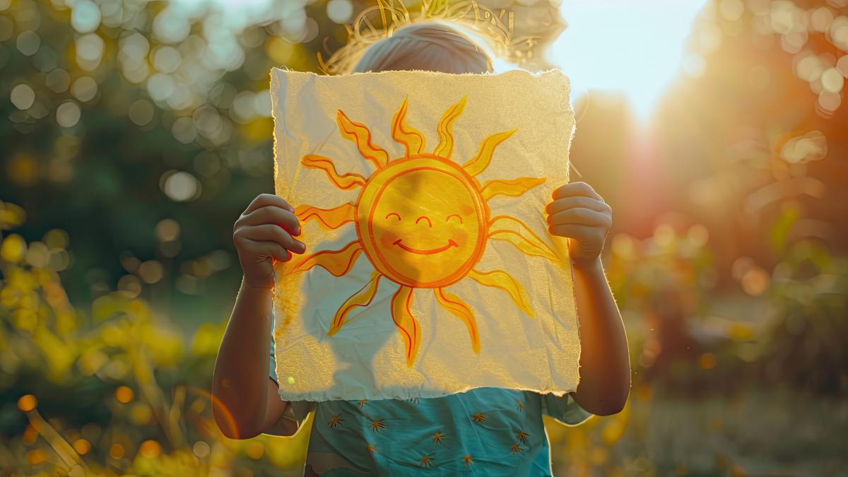 child-is-holding-sheet-paper-with-sun-selective-focus_66100400
