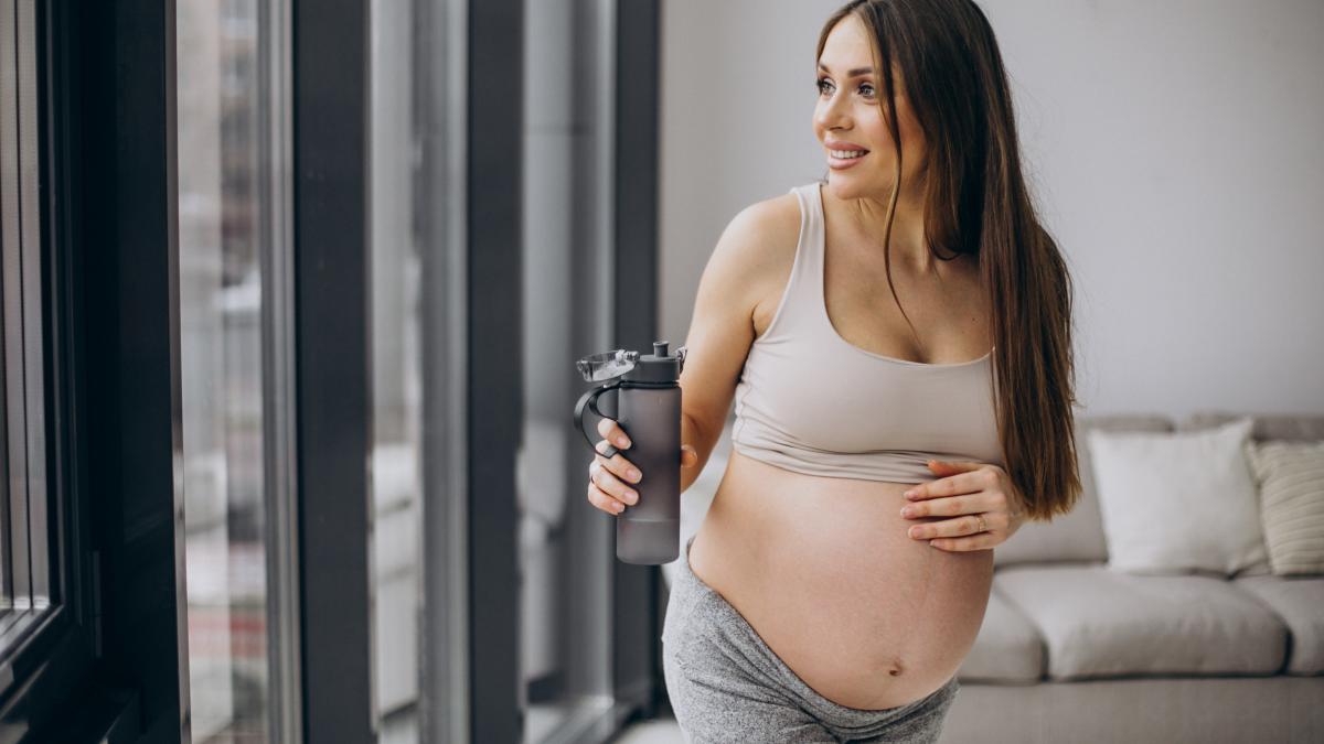 pregnant-woman-having-rest-after-exercising-home_46434200