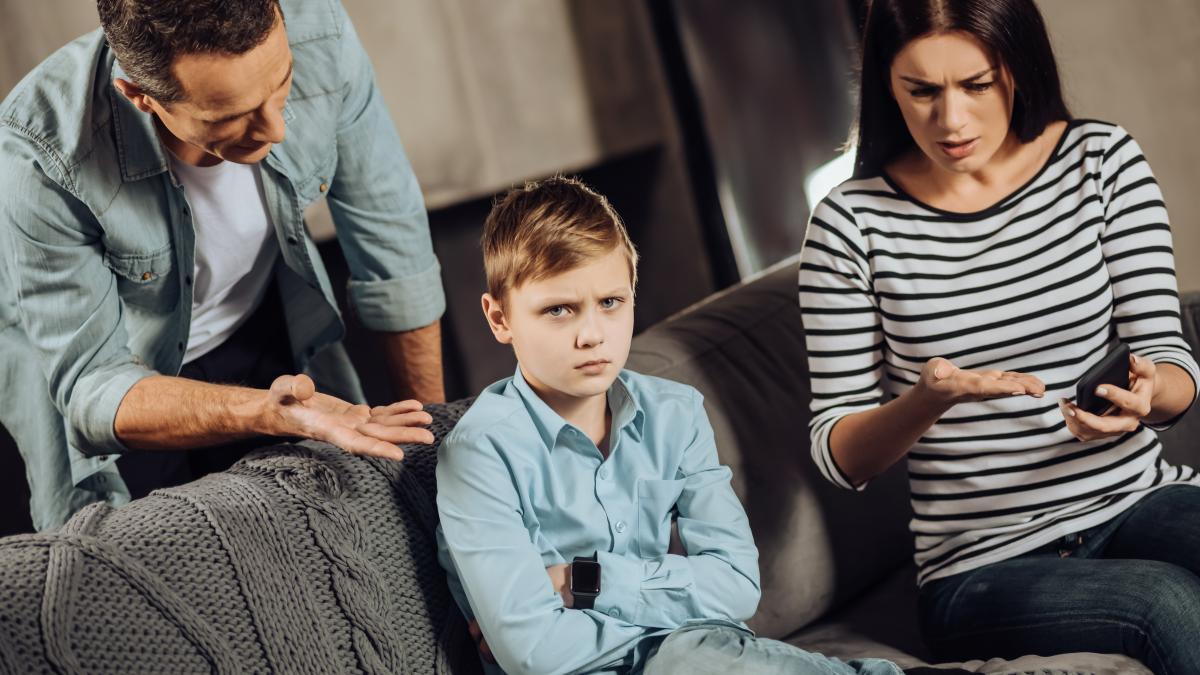 educational-moment-pleasant-young-parents-being-gathered-around-their-son-explaining-him-reasons-taking-his-phone-away-while-boy-looking-hurt-indignant_75749000