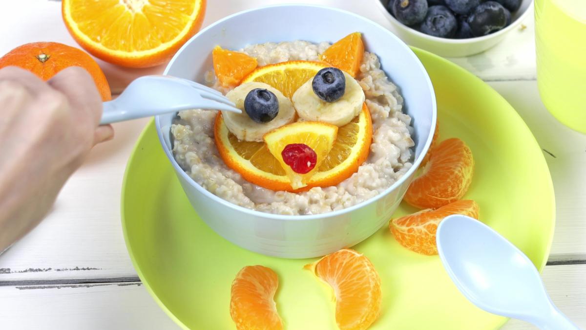 children-s-breakfast-oatmeal-with-fruits-nuts-fox-muzzle-made-oranges-healthy-food-kids-1_92464500