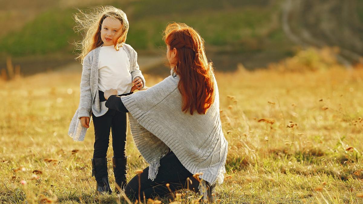 mother-with-little-daughter-playing-autumn-field_49682500