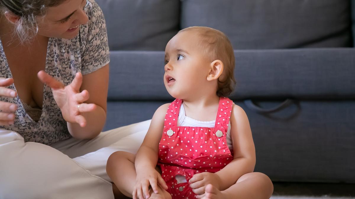 cute-little-girl-listening-mom-with-open-mouth-looking-her-cropped-mother-sitting-cross-legged-floor-talking-daughter-lovely-infant-sitting-barefoot-weekend-motherhood-concept_42315900
