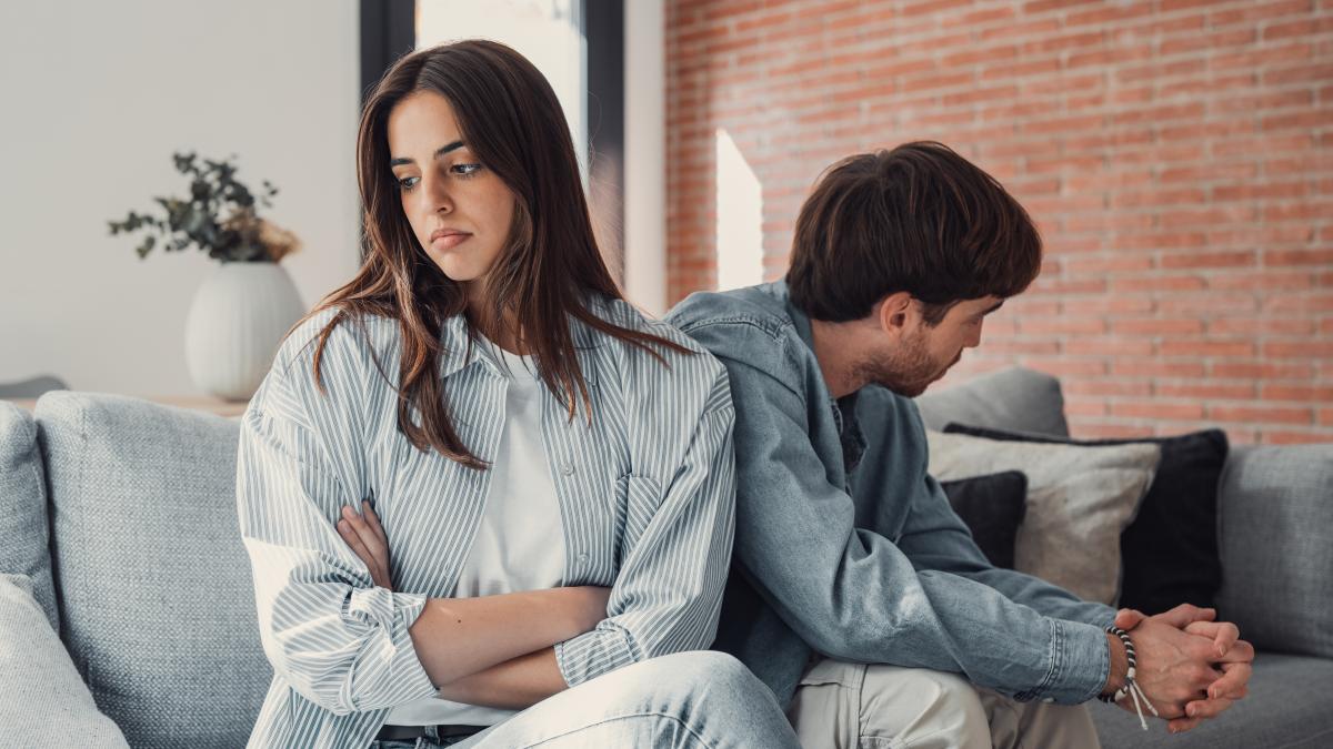 beautiful-lady-is-depressed-sitting-couch-talking-man-having-dispute-with-husband-boyfriend-looking-desperate-hopeless-having-unresolved-problem-questionxa_77411900