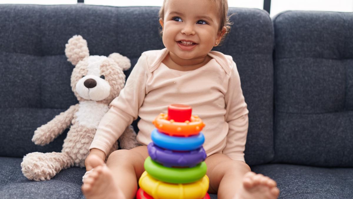 bebeluș care se joacă și zâmbeste